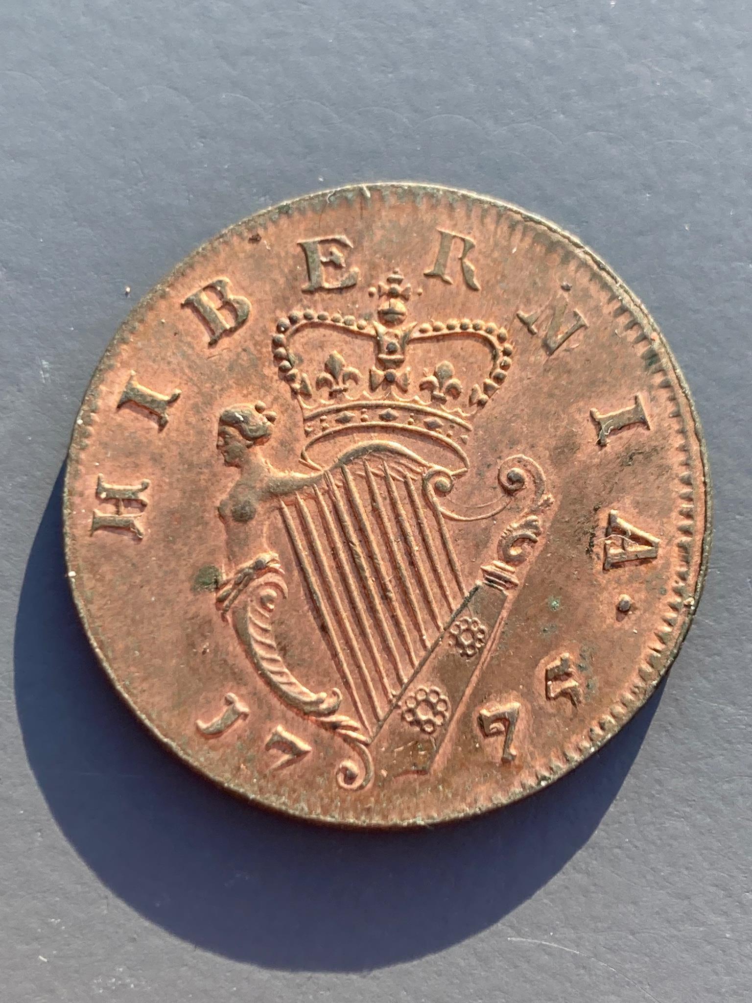 Ireland coins, a George III Irish Halfpenny, 1775, Type III, laureate bust with long hair, rev. crowned harp (DF 584; S.6614), weakness to edge otherwise about uncirculated, with some original lustre